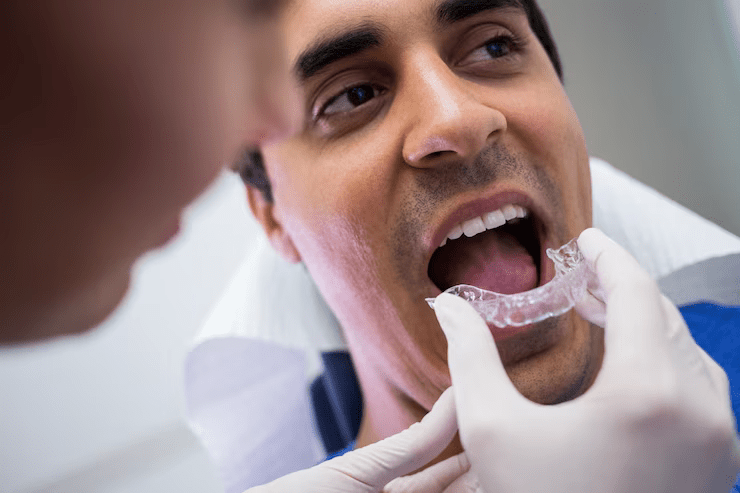 Dentist assisting patient wear invisible braces