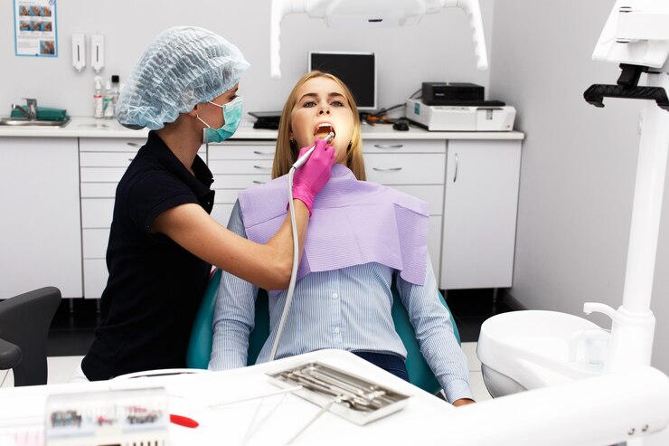 Female dentist treating her patient's teeth