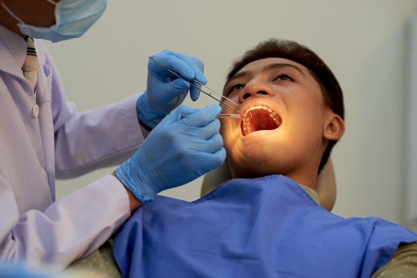young man sitting mouth wide open office dentist annual examination 1098 20340